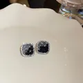 Elegant square silver needle stud earrings with black and grey crystals on a plate - Square Patchwork Micro-set Style