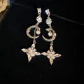 Elegant long drop earrings featuring silver finish and crystal-encrusted moon and star charms. - Star Moon Tassel