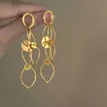Elegant gold hollow circle tassel earrings detail highlighting the smooth metallic finish. - Silver Earring Post Style / Gold