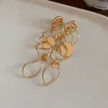 Elegant gold hollow circular tassel earrings with hypoallergenic silver needles. - Clip-on Style / Gold