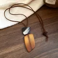 Close-up of irregular resin pendant necklace with vintage brown cord - Necklace Style 3 (WN1630)