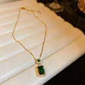 Detailed macro view of the rectangular emerald green pendant with sparkling crystals - Emerald Green Necklace (Gold)
