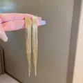 Eleganti orecchini lunghi con nappa dorata e dettagli in frangia a catena - Nappina a Catena Fine Oro (18#)