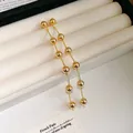 Eleganti orecchini pendenti lunghi in oro con nappe e perle tonde lucide da donna - Perle Placcate Oro Vero (40#)