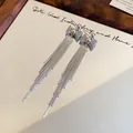Eleganti orecchini lunghi con nappa d'argento e design a fiocco in rete metallica - Fiocco Argento Placcato Oro Vero (48#)