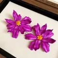 Close-up of purple acrylic flower statement earrings with yellow seed bead centers. - Silver Needle / Purple