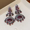 Macro detail of luxury fan-shaped earrings with red zircon drops and vintage court style - Fan Style with Silver Post / Gunmetal-Red-Pink