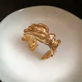 Detailed view of an irregular gold crumpled metallic cuff bracelet with unique lava texture - Bangle / Gold