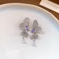 Detail of hollow butterfly earrings with purple crystals and teardrop tassel pendant - Silver
