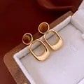 Close-up of vintage gold rectangular earrings with a polished tiger eye stone - Golden Irregular Amber Square (24#)