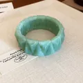 Detail view of the faceted green marbled resin bracelet displayed on a textured surface - Green (27#)