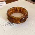 Detail view of amber tortoiseshell geometric faceted chunky bracelet on textured fabric - Dark Coffee (25#)