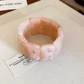 Detailed macro view of a pink marbled resin block stretch bracelet on a neutral linen background - Pink (20#)