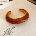 Close-up of vintage amber resin textured cuff bracelet on display - Coffee (4#)