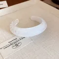 Detail shot of a minimalist white textured resin oval open cuff bracelet for women - White (1#)