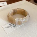Detail view of cream marbled acrylic chunky stretch bracelet with elegant vintage texture - Light Coffee (52#)