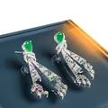 Elegant ethnic skirt-shaped earrings with green teardrop stones and colorful crystals. - Silver-Green-Pink