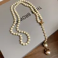 Elegant long baroque pearl necklace with gold bird charm and vintage style drop pearls detail - Gold-White