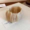 Elegant marbled resin bangle with swirled cream texture on display tray. - Light Coffee (40#)