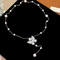 Detailed view of an elegant zircon butterfly pearl necklace on a black velvet background - Silver (Pink Butterfly)