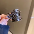 Detail of metallic spiral wire hair claw clip with high gloss finish and compact design - Cross Style (7#)