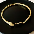 Close-up of golden snake choker featuring intricate scale texture and green eyes - Snake Style (WN034) / Gold