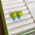 Close-up detail view of vibrant green and blue resin double-sphere stud earrings in tray - 6# Two-Tone Ball Style / Green - Blue