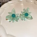Close-up of mint green resin flower earrings with teal center on a ceramic plate - 46# Color Block Translucent Lacquered Resin Style / Mint Green-Peacock Blue