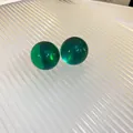 Close-up view of forest green spherical resin stud earrings on a ribbed surface - 48# Perfect Round Sphere Translucent Style / Dark Green