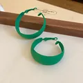 Close-up view of green matte spray-painted hoop earrings in a forest style design - 49# Matte Lacquered Round Style / Grass Green