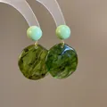 Detail view of forest style marbled green resin earrings featuring a mint bead stud. - 50# Dual Bead and Disc Combo Style / Light Green-Dark Green