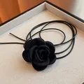 Close-up detail of a handmade black fabric rose choker with multi-layer leather cords. - Small (Rose) / Black