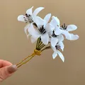 Close-up of elegant white fabric flower hair pin with golden double-pronged fork - Satin Fabric Hairpin / White