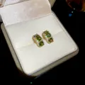 Elegant gold-plated stud earrings with three round green gemstones in a jewelry box - 60# Real Gold Plated Olive Green Zirconia Style / Gold-Green