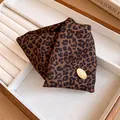Macro view of the retro leopard print fabric texture on a triangle hair claw clip. - Triangle Hair Claw / Dark Brown Plaid Claw Clip