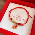 Macro detail of red woven rope bracelet with glass beads and rocking horse charm - Chen Shun Enamel Rocking Horse (Style 21)