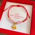 Detail of red braided rope bracelet with pink beads and a golden rocking horse charm - Pink Beaded Rocking Horse (Style 14)