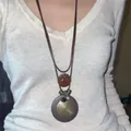 Close-up detail of bohemian ethnic style pendant necklace worn by female model - 4# Style - Bow