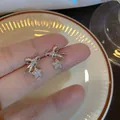Elegant silver pin zircon bow and star stud earrings for women in a luxury design - Silver
