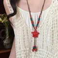 Detailed close-up of a Bohemian ethnic woven necklace featuring a vibrant red star pendant - Style 28