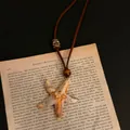 Close-up of a realistic starfish pendant necklace resting on vintage book paper. - 31# Style - Realistic Starfish