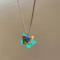 Detailed view of bohemian butterfly pendant with teal enamel and colorful rhinestones - 34# Style - Butterfly Flower Cluster