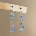 Künstlerische blaue Blumenquasten-Ohrringe mit Silbernadeln auf Holzständer - Asymmetrischer Quastenblumenstil (24#)