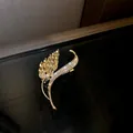 Detailed close-up of elegant gold-plated wheat leaf brooch decorated with sparkling crystals - Wheat Ear Shape (HP390)