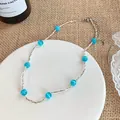 Vintage silver-tone necklace featuring vibrant blue cat eye beads on a white ceramic plate - Blue Cat Eye Stone Style / 41# Necklace Silver Blue