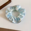 Detailed view of a sweet blue and white floral print fabric scrunchie hair accessory - Light Blue Floral Style (13#)