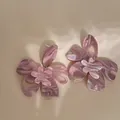 Macro detail of mauve marble resin flower earrings with artistic swirl pattern and layered petals. - Flower Style (HE20149-1) / Pink Marbled