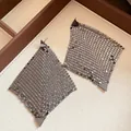 Detailed view of gunmetal metallic mesh diamond-shaped earrings in a jewelry tray - Gunmetal