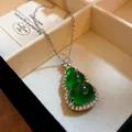 Macro detail showing a green resin gourd pendant necklace with sparkling zircons - Green