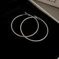 Minimalist large silver metal hoop earrings for women featuring a stylish circular design - Diameter 60mm / Silver